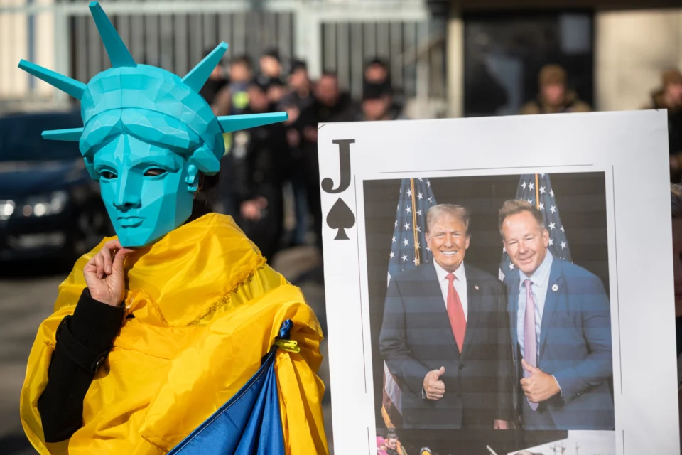 KYIV, UKRAINE - MARCH 08: A person wears a mask symbolizing the Statue of Liberty as Ukrainians, holding banners and flags, hold a rally in front of the US embassy to protest the actions of the US President Donald Trump administration considering the ongoing Russia-Ukraine war on March 08, 2025 in Kyiv, Ukraine.